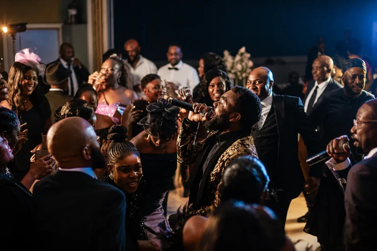 DJ Sabs mixing at a live event with the crowd in the background